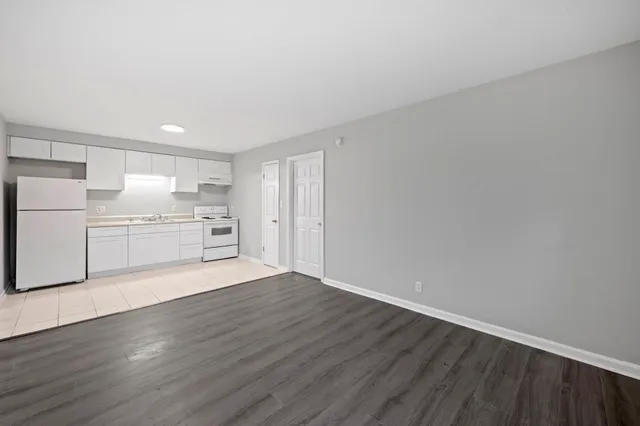 a view of a kitchen with a sink and a refrigerator