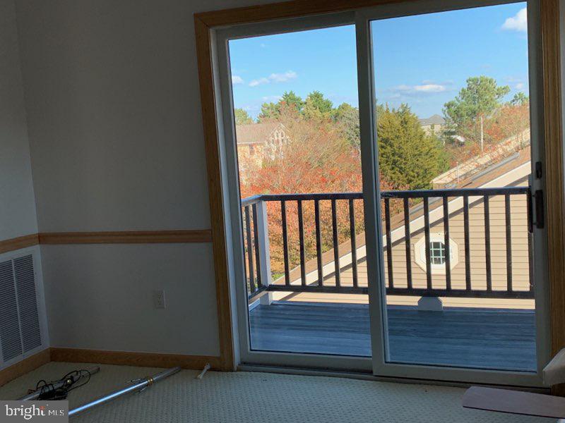 38852 Bayfront Drive Ocean View, DE 19970 - Photo 18 of 28 an empty room with wooden floor and a window