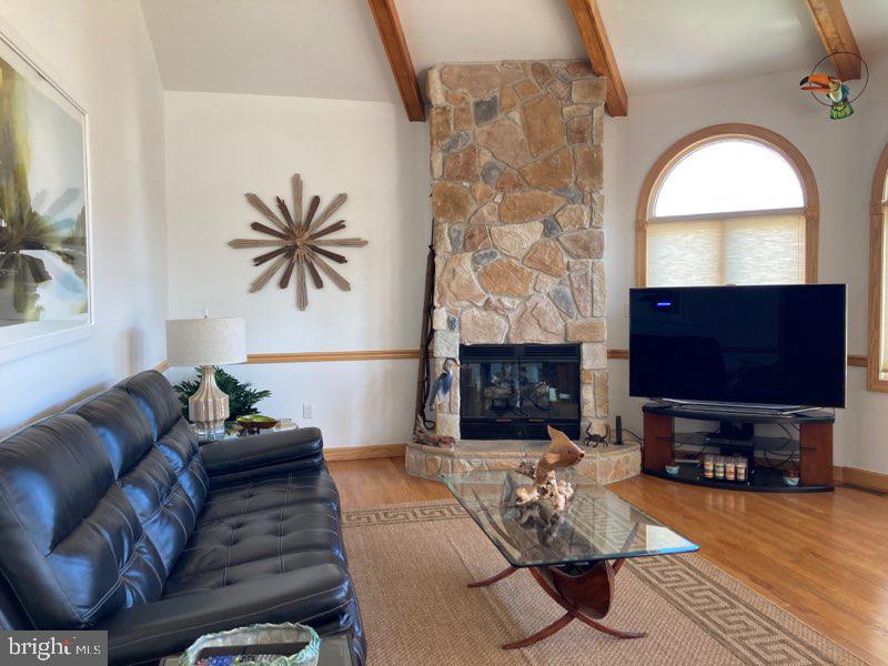 38852 Bayfront Drive Ocean View, DE 19970 - Photo 2 of 28 a living room with furniture a fireplace and a flat screen tv
