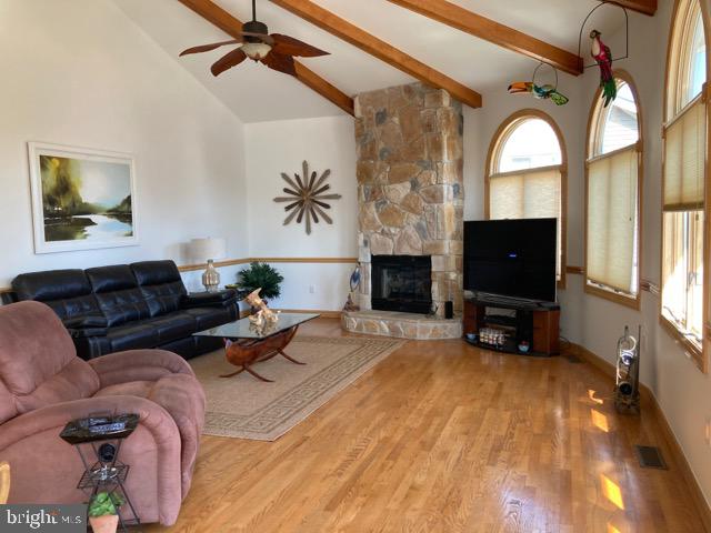 38852 Bayfront Drive Ocean View, DE 19970 - Photo 3 of 28 a living room with furniture a fireplace and a flat screen tv