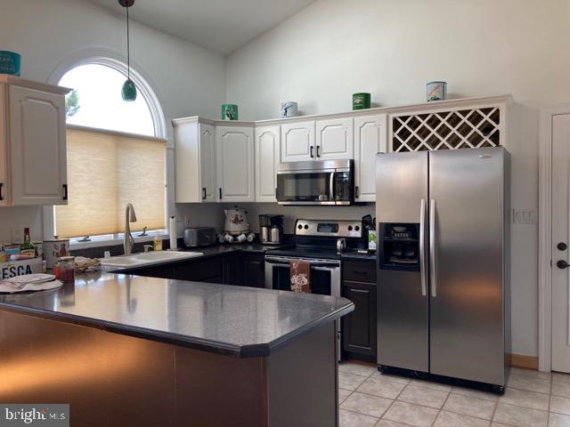 38852 Bayfront Drive Ocean View, DE 19970 - Photo 7 of 28 a kitchen with kitchen island a counter space a sink appliances and cabinets