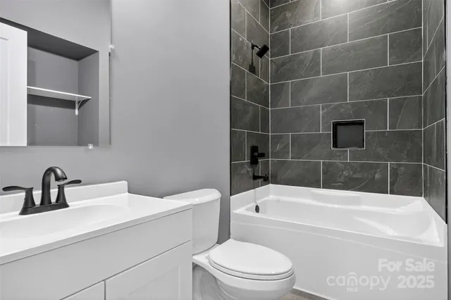 a bathroom with a sink a toilet and bathtub