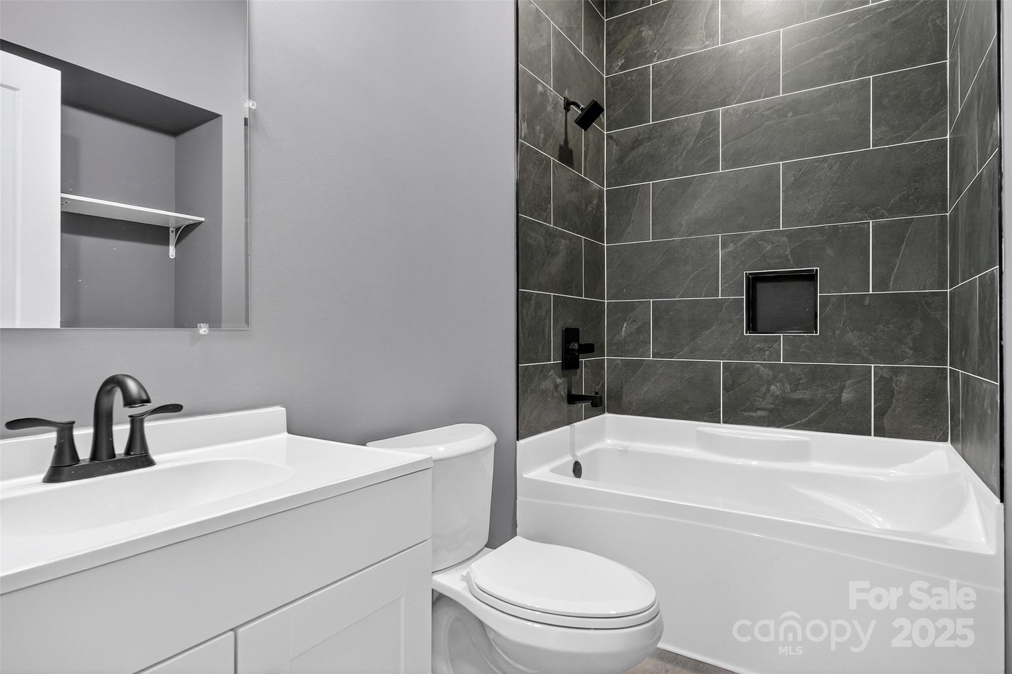 7663 Keistlers Store Road Sherrills Ford, NC 28673 - Photo 28 of 45 a bathroom with a sink a toilet and bathtub