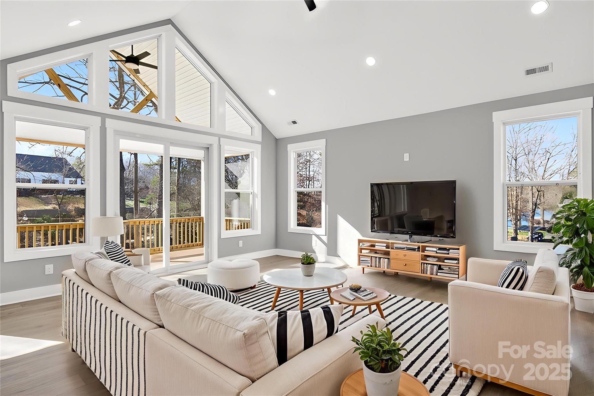 7663 Keistlers Store Road Sherrills Ford, NC 28673 - Photo 32 of 45 a living room with furniture a flat screen tv and a large window