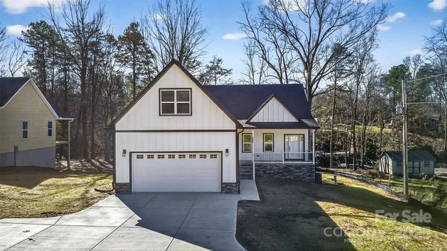 a view of a house with a yard covered in snow
