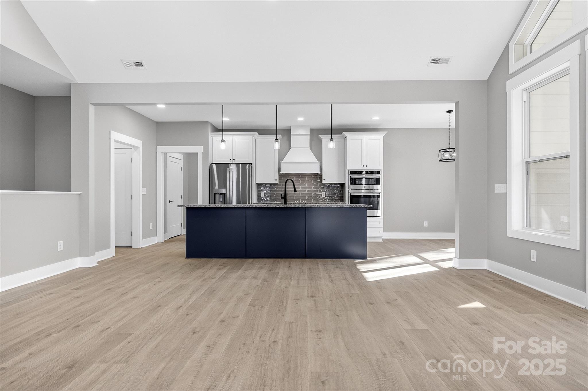 7663 Keistlers Store Road Sherrills Ford, NC 28673 - Photo 10 of 45 a view of a kitchen with wooden floor and windows