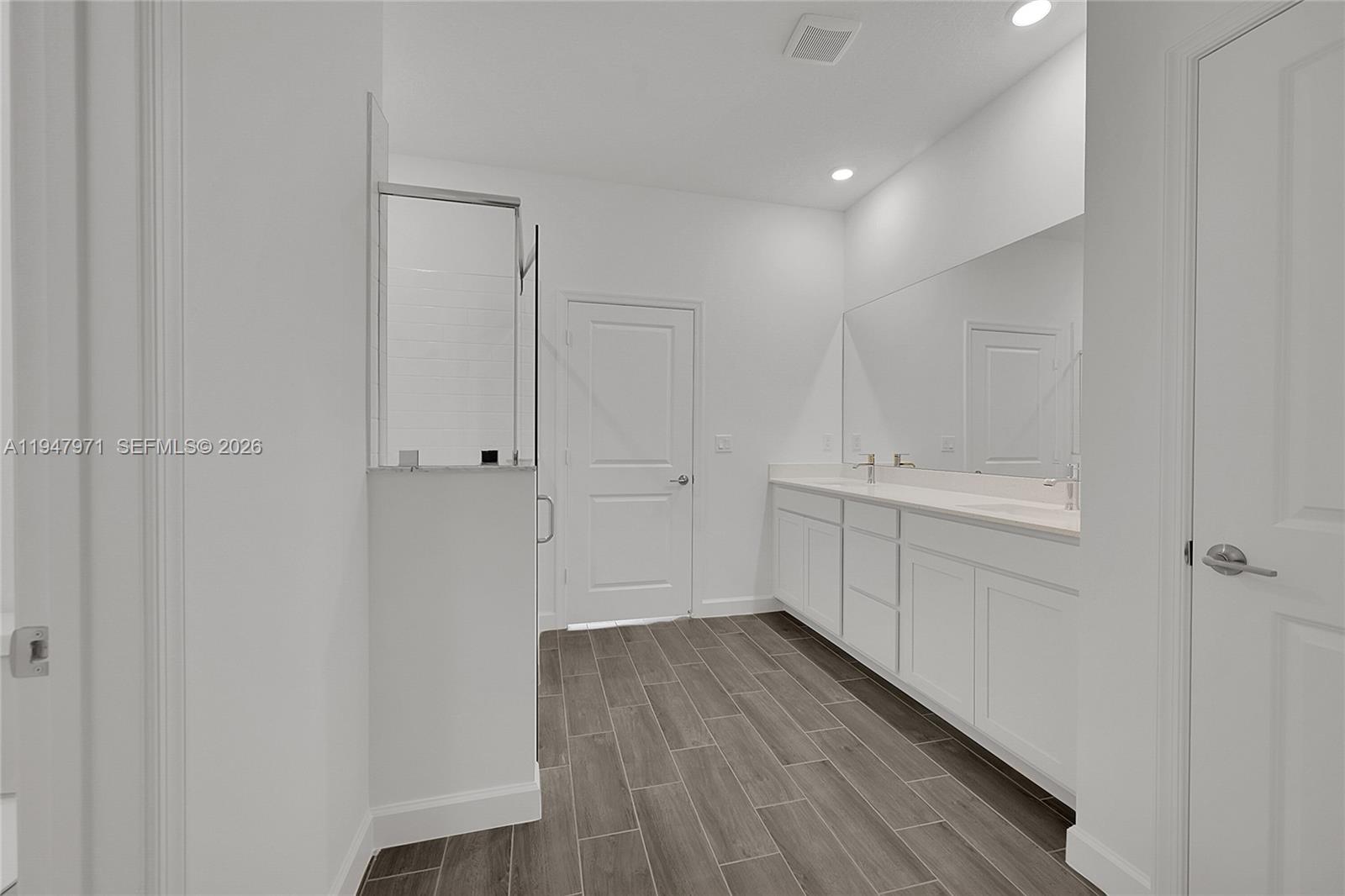 19465 Whispering Creek Road Loxahatchee, FL 33470 - Photo 11 of 22 a bathroom with a sink a toilet and a mirror