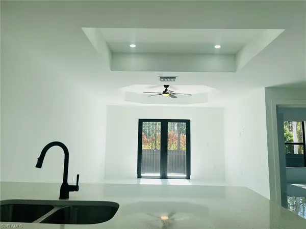 a view of a sink and dishwasher with wooden floor