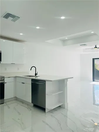 a view of a sink and dishwasher in a kitchen