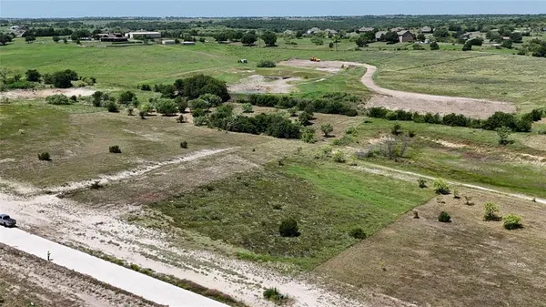 an aerial view of a houses with a yard