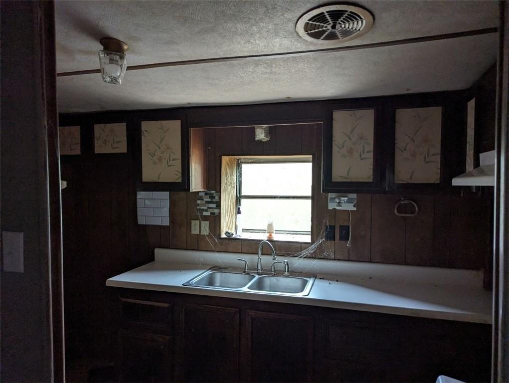 1172 Midway Road Northwest Resaca, GA 30735 - Photo 8 of 25 a kitchen with a sink and a refrigerator