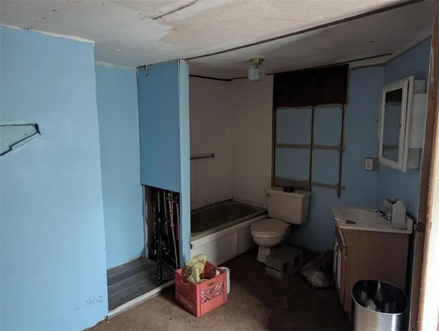 a room with water heater and wooden walls