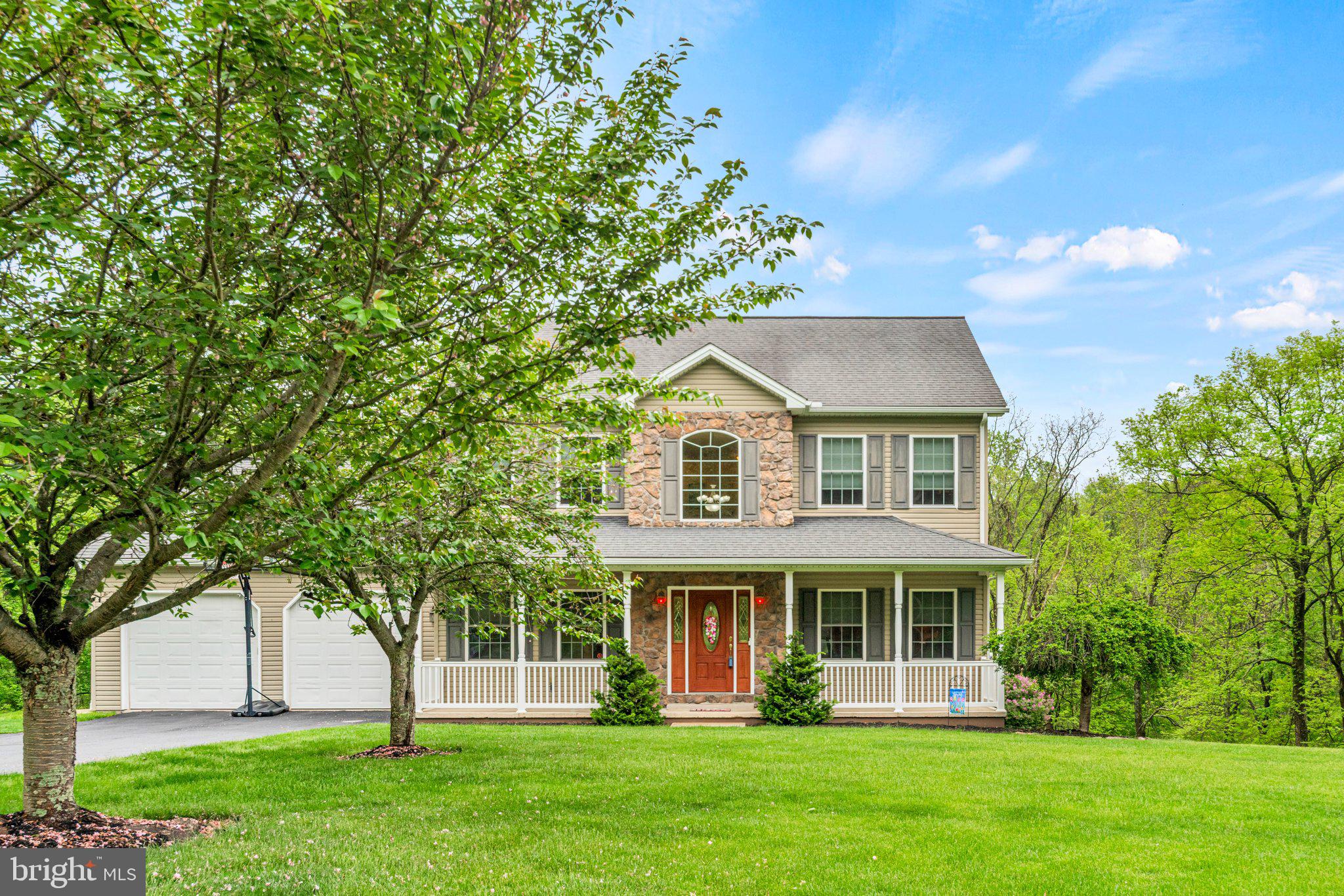 159 Dividing Ridge Road Halifax, PA 17032 - Photo 1 of 57 a front view of a house with a garden and trees