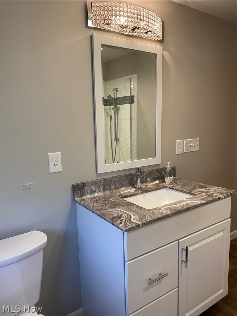 14549 Cedar Road Cleveland, OH 44121 - Photo 16 of 23 Upstairs - Bathroom with hardwood / wood-style flooring, vanity with extensive cabinet space, and toilet
