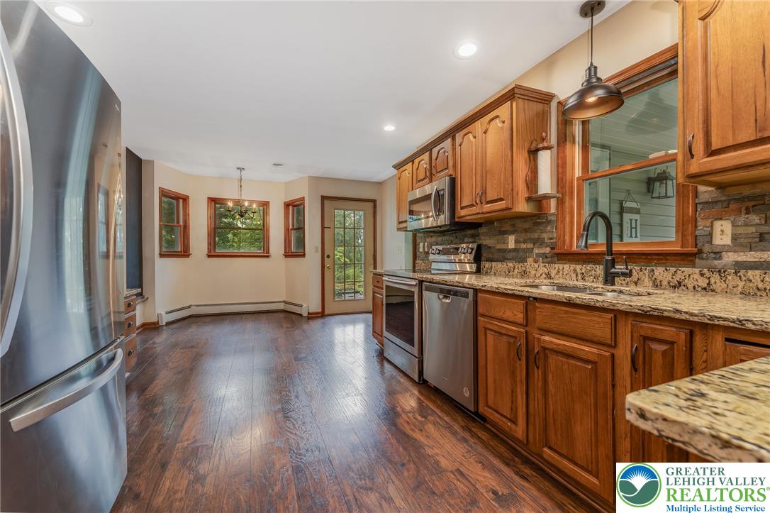 465 Raubsville Road Easton, PA 18042 - Photo 17 of 60 A well-appointed kitchen features stainless steel appliances, granite counters, and rich Laminate flooring.