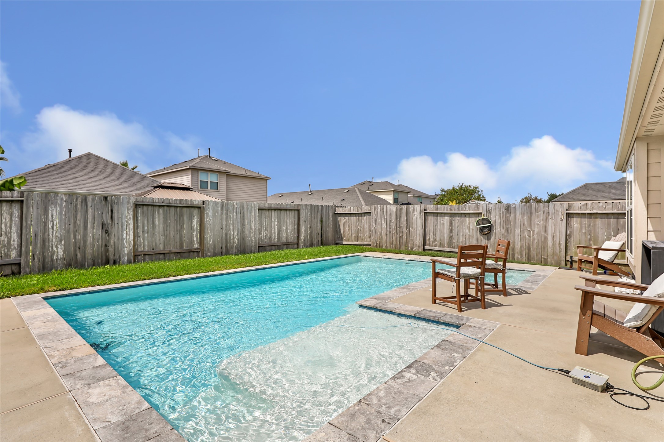 a view of a backyard with a table and chairs