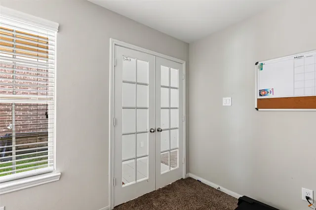 a living room with furniture and a gym equipment