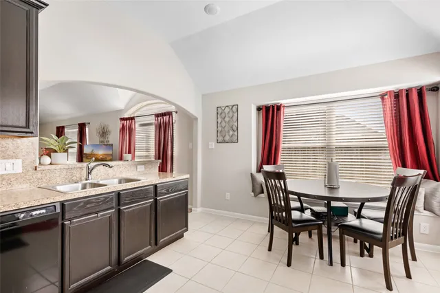 a kitchen with a stove a sink and a microwave