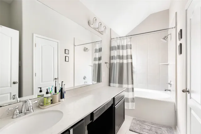 a bathroom with a shower and a sink