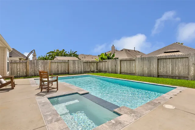 a front view of a house with patio and garden