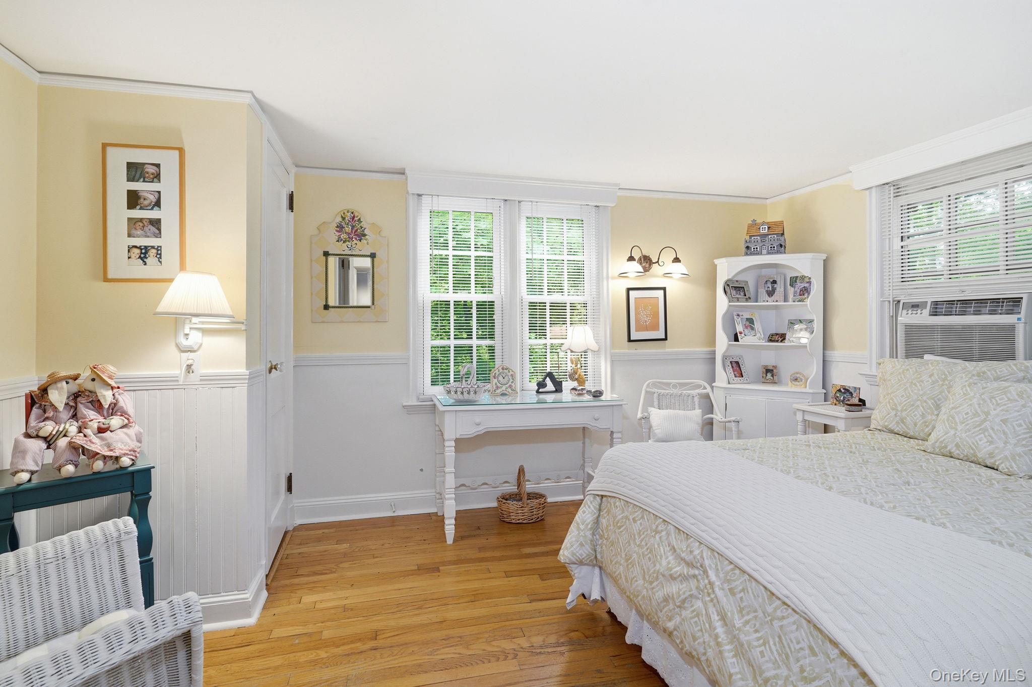 26 Cedarlawn Road Irvington, NY 10533 - Photo 25 of 34 a spacious bedroom with a bed and a table in it