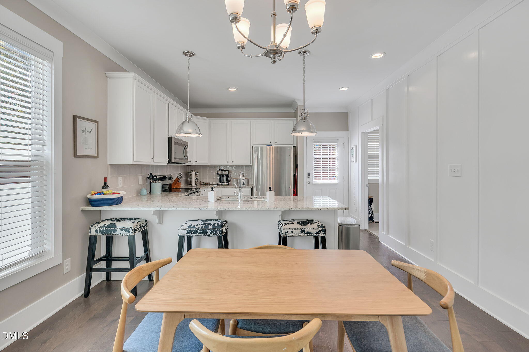 510 Eugene Street Durham, NC 27701 - Photo 12 of 42 a large kitchen with kitchen island a table and chairs in it