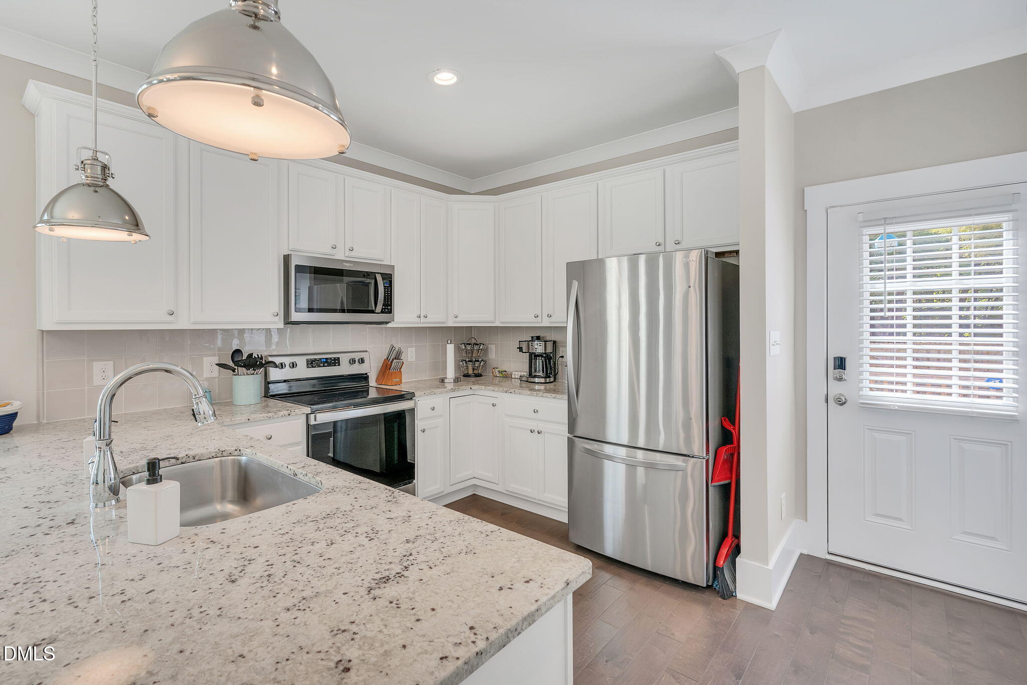 510 Eugene Street Durham, NC 27701 - Photo 13 of 42 a kitchen with granite countertop stainless steel appliances a refrigerator sink and microwave