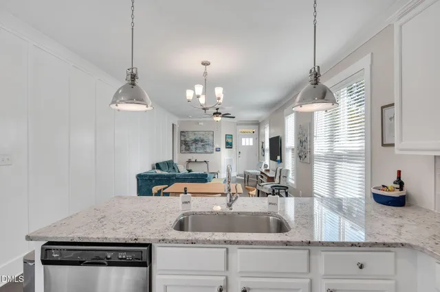 a kitchen with sink stove and cabinets