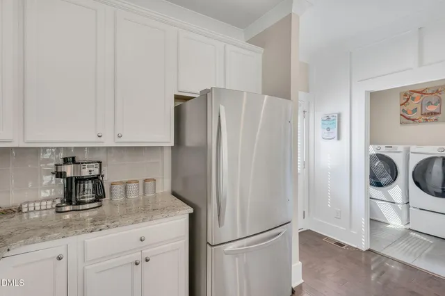 a kitchen with stainless steel appliances granite countertop a refrigerator and a stove top oven