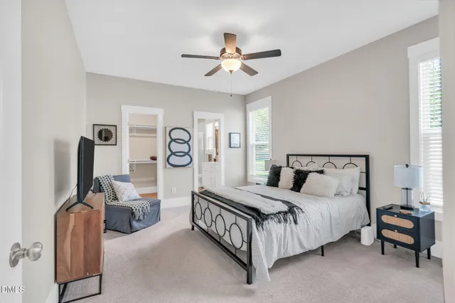a bedroom with bed and a chandelier