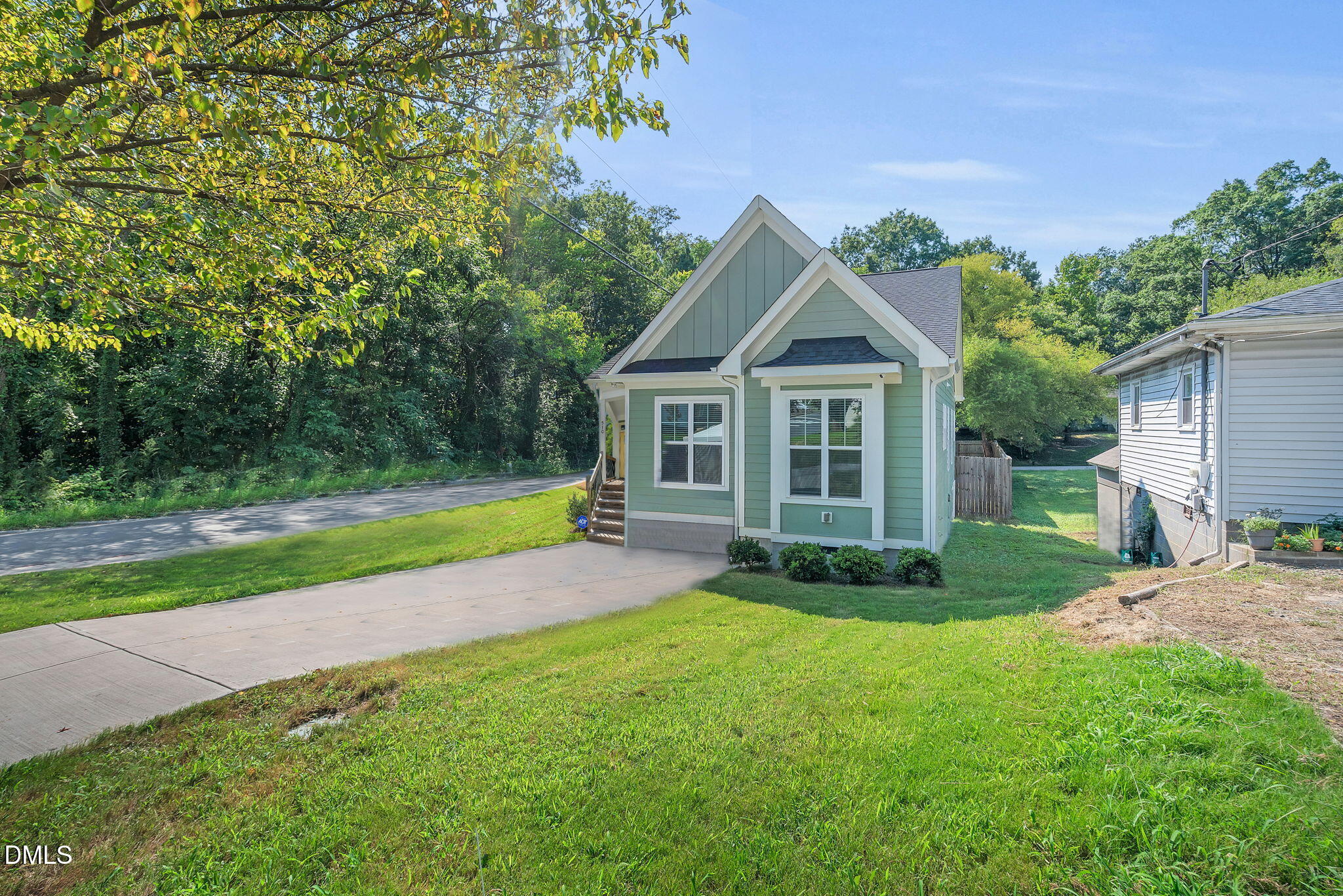 510 Eugene Street Durham, NC 27701 - Photo 2 of 42 a view of a house next to a big yard and large trees