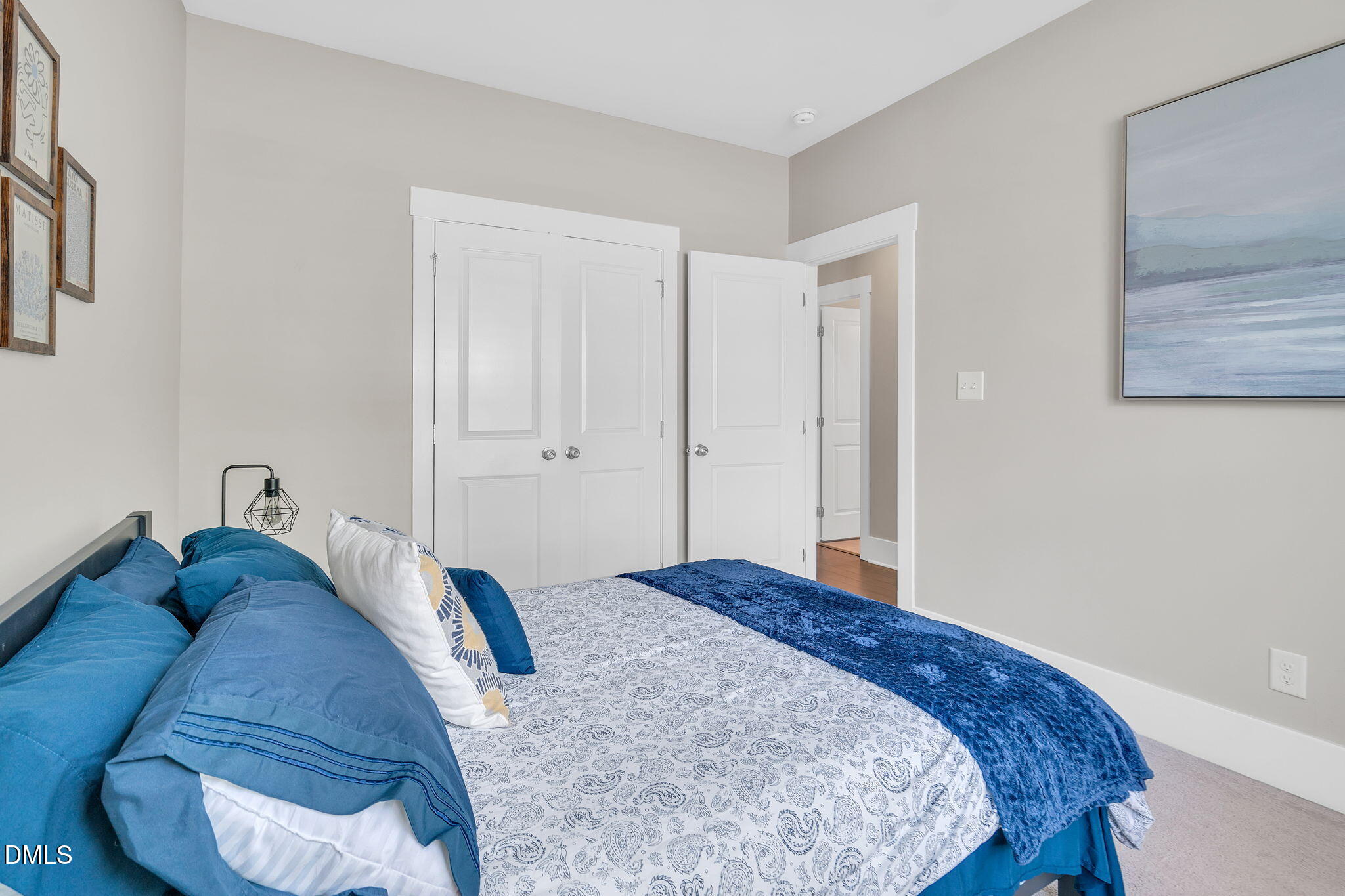 510 Eugene Street Durham, NC 27701 - Photo 28 of 42 a bedroom with a bed and a painting on the wall