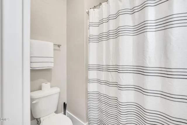 a bathroom with a sink a toilet and a shower