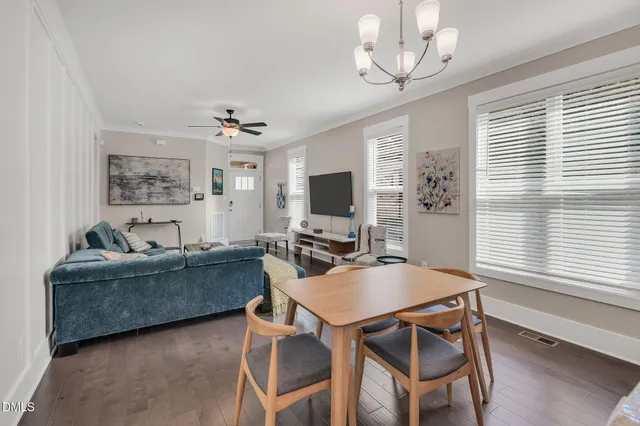 a living room with furniture a large window and a flat screen tv