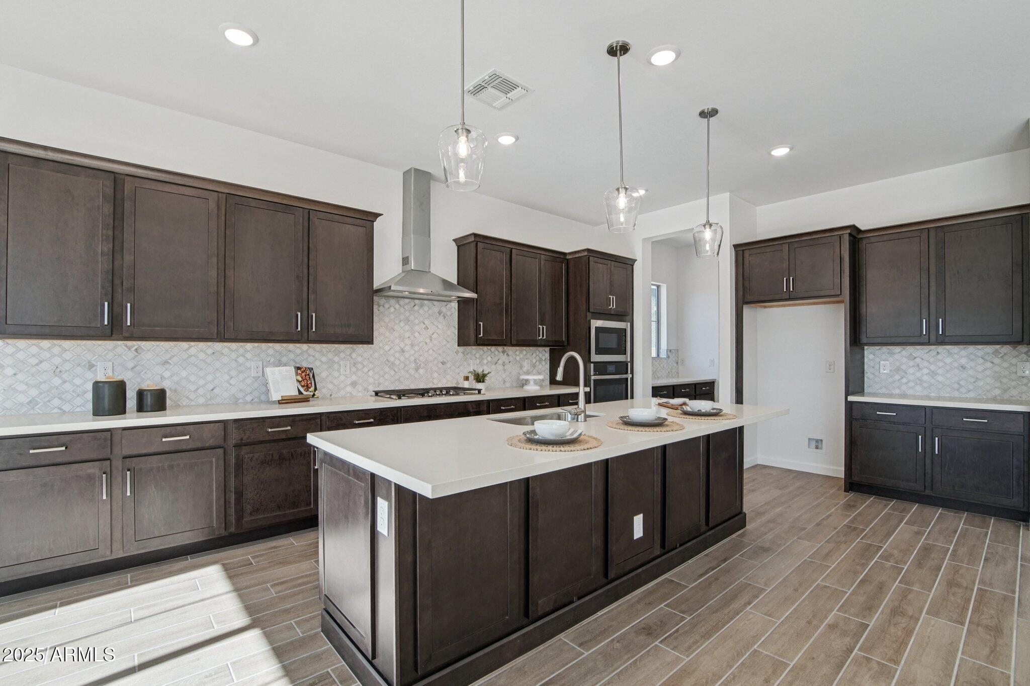 22725 East Saddle Way Queen Creek, AZ 85142 - Photo 12 of 48 a kitchen with a sink stove and refrigerator