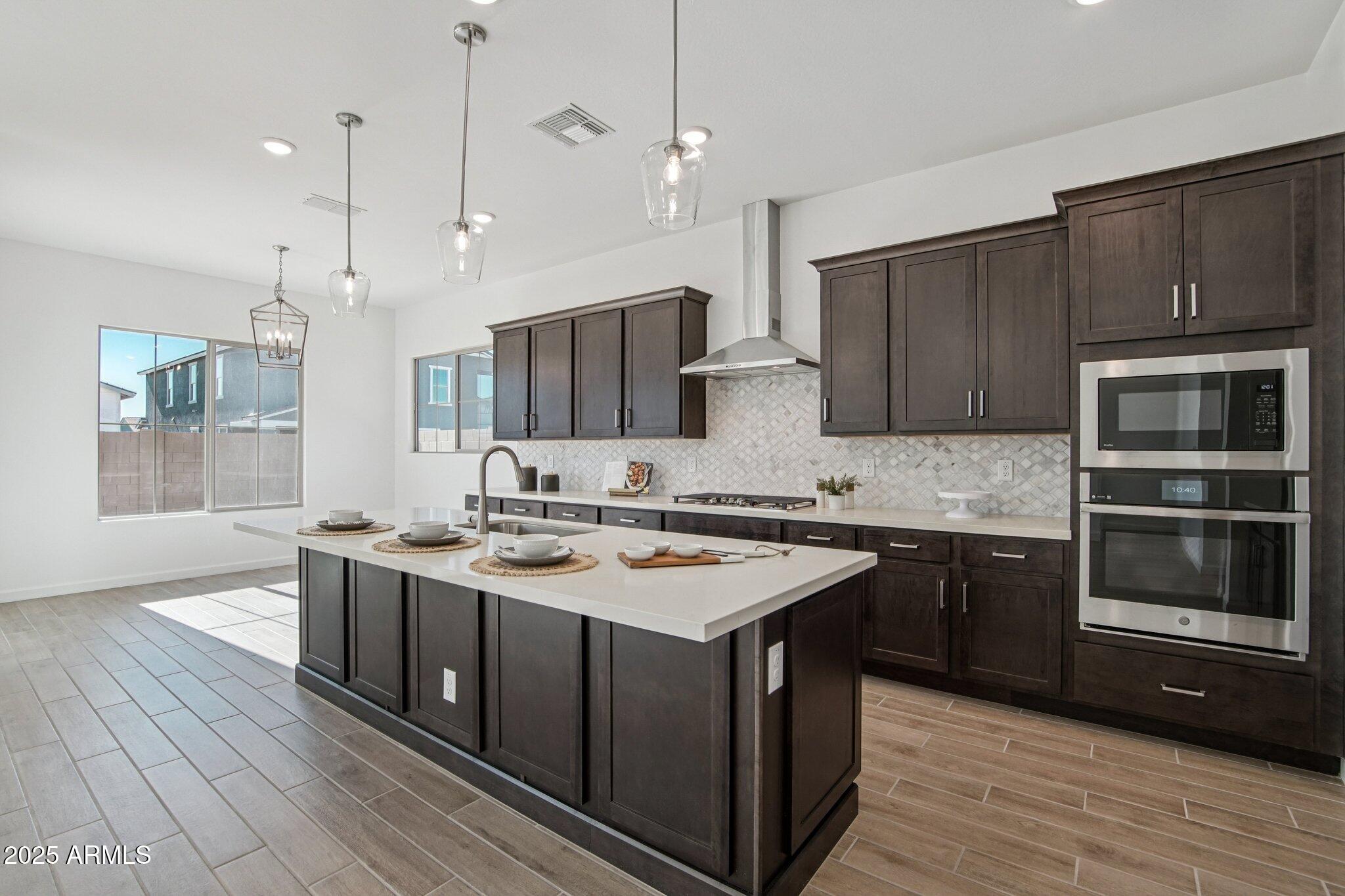 22725 East Saddle Way Queen Creek, AZ 85142 - Photo 13 of 48 a kitchen with stainless steel appliances granite countertop a sink stove and oven