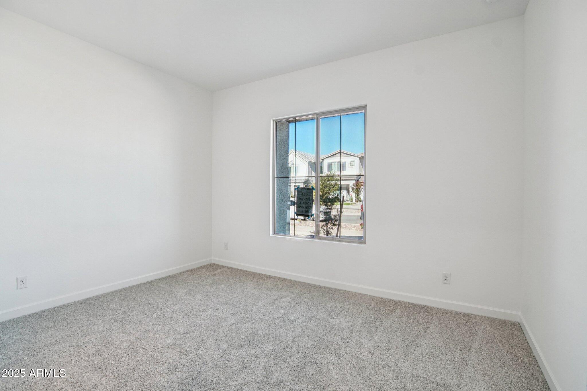 22725 East Saddle Way Queen Creek, AZ 85142 - Photo 18 of 48 an empty room with windows