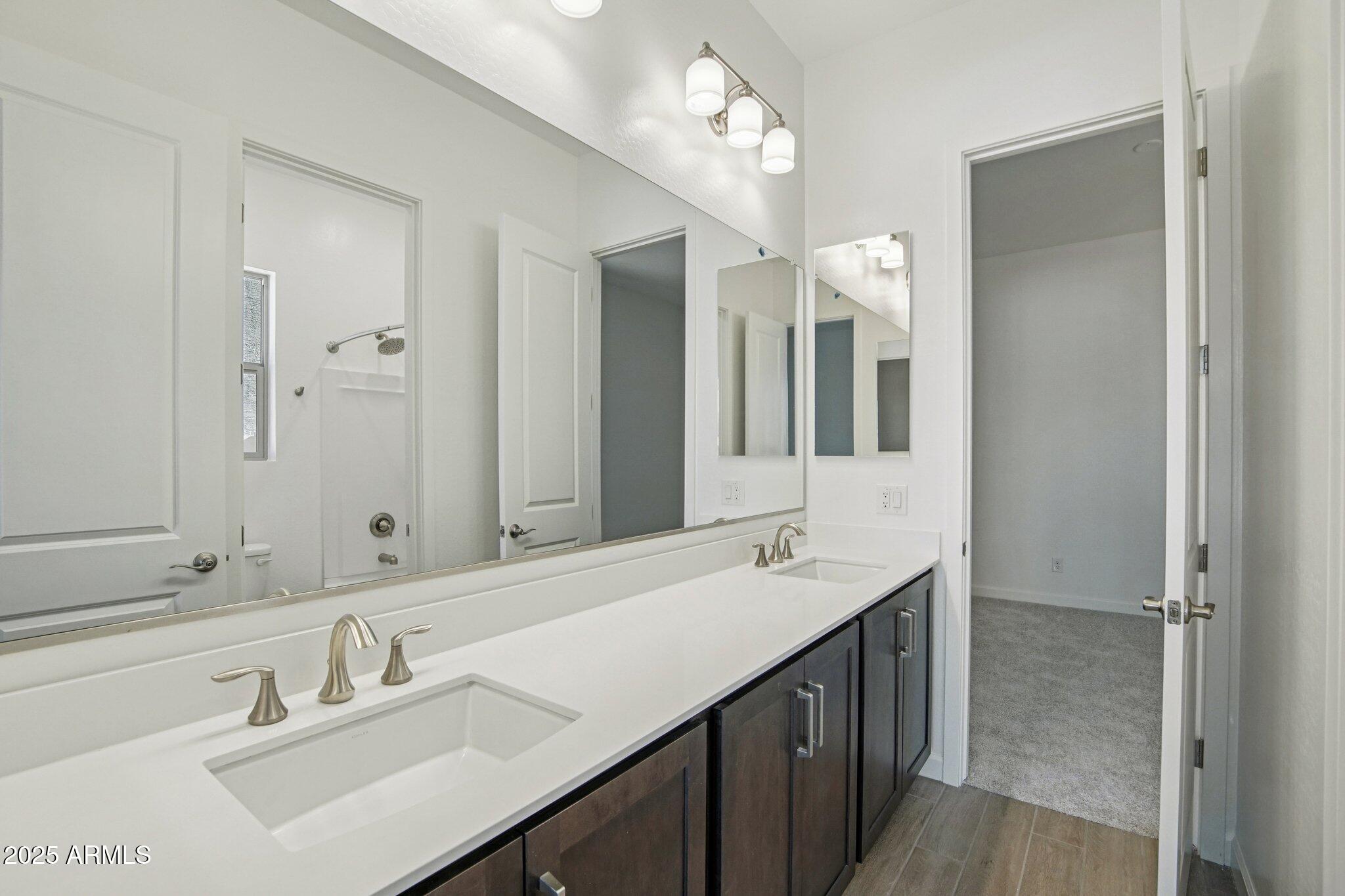 22725 East Saddle Way Queen Creek, AZ 85142 - Photo 20 of 48 a bathroom with a sink double vanity and a mirror