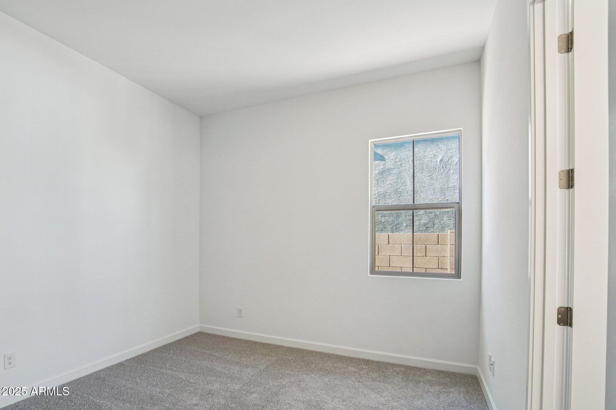 22725 East Saddle Way Queen Creek, AZ 85142 - Photo 21 of 48 an empty room with a window