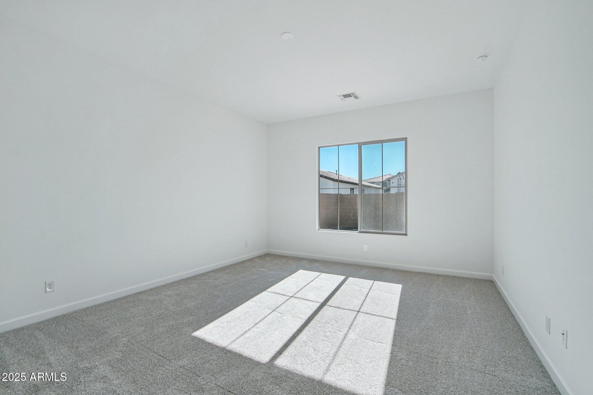 22725 East Saddle Way Queen Creek, AZ 85142 - Photo 25 of 48 an empty room with windows