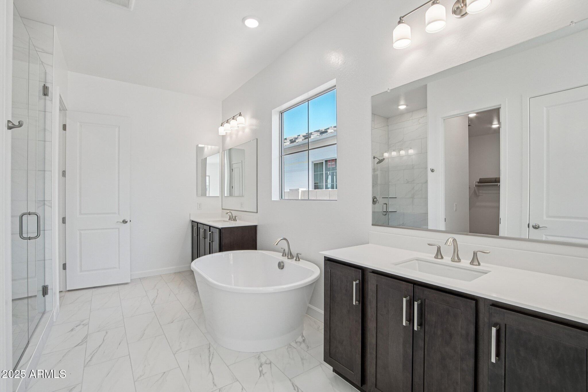 22725 East Saddle Way Queen Creek, AZ 85142 - Photo 28 of 48 a bathroom with a sink and a mirror
