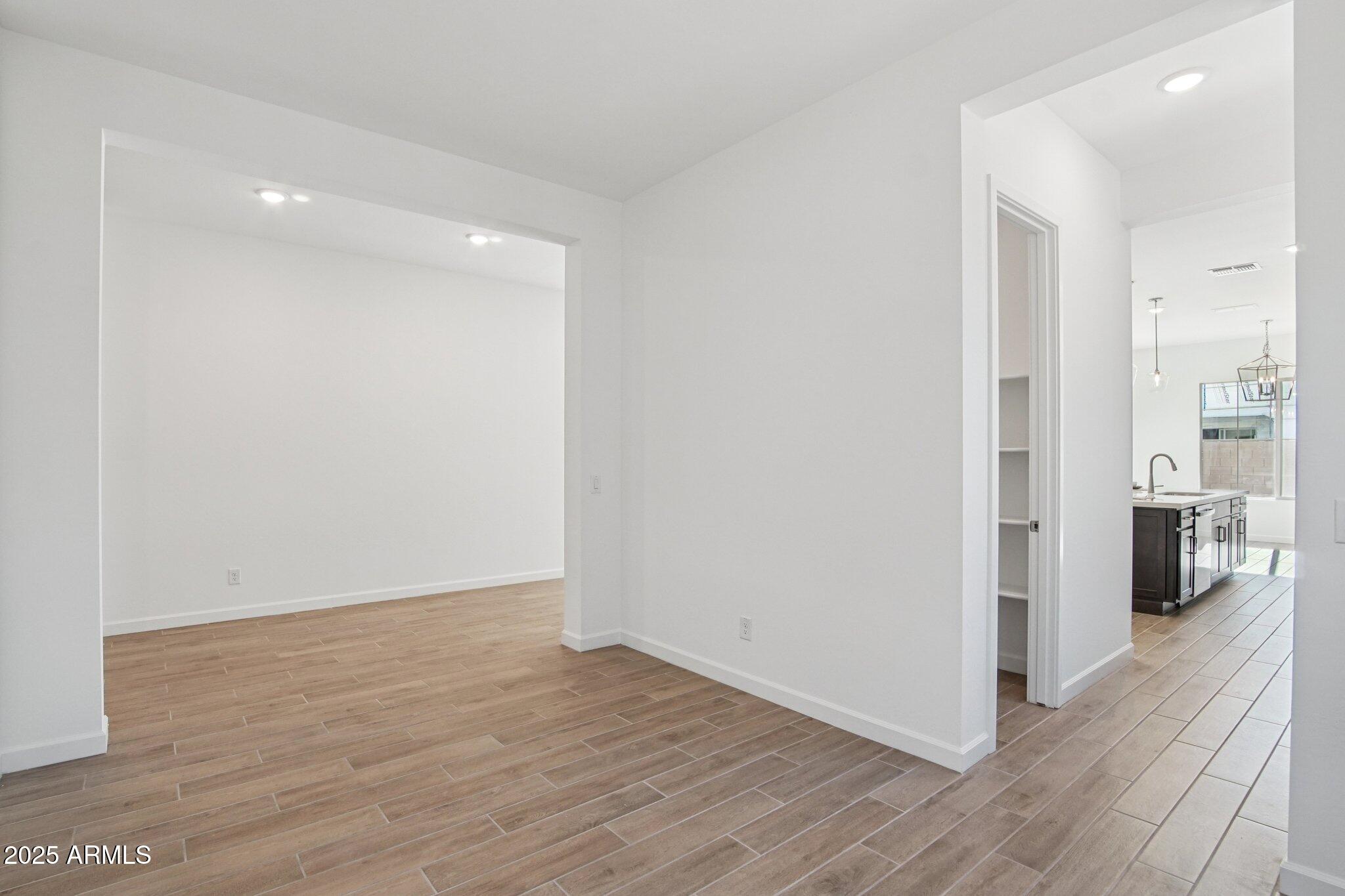 22725 East Saddle Way Queen Creek, AZ 85142 - Photo 8 of 48 wooden floor in an empty room with wooden floor