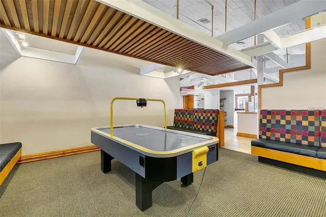 a room with pool table and windows