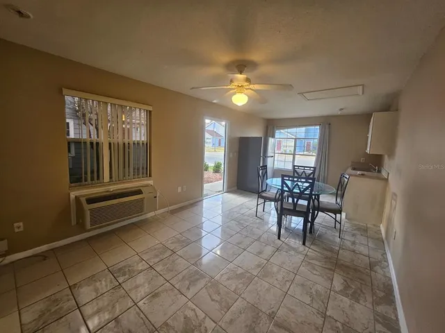 a view of a livingroom with furniture and a ceiling fan