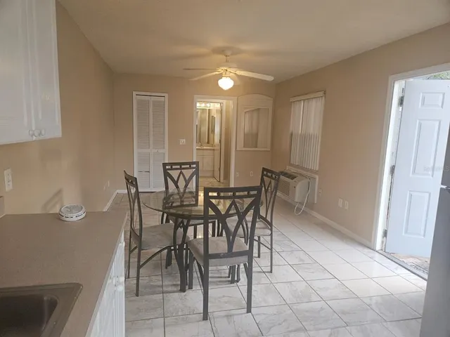 a view of a dining room with furniture and chandelier