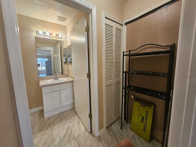 a bathroom with a sink a mirror and a shower