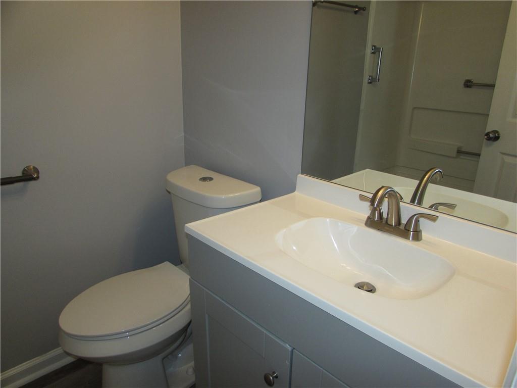 835 Heritage Valley Road Norcross, GA 30093 - Photo 29 of 34 a bathroom with a sink a toilet and a mirror