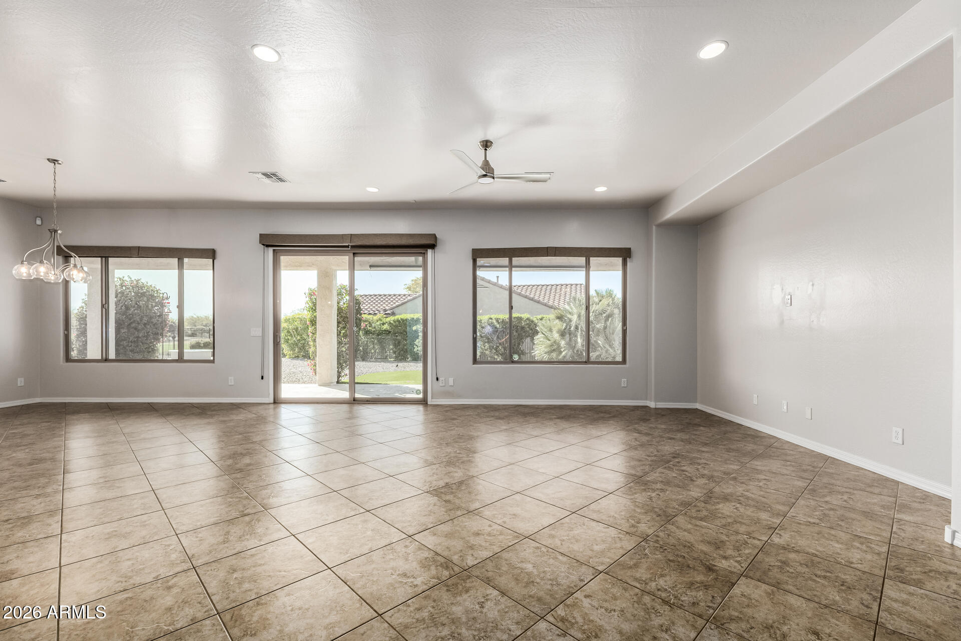 27119 West Burnett Road Buckeye, AZ 85396 - Photo 11 of 56 an empty room with windows and view of an empty room