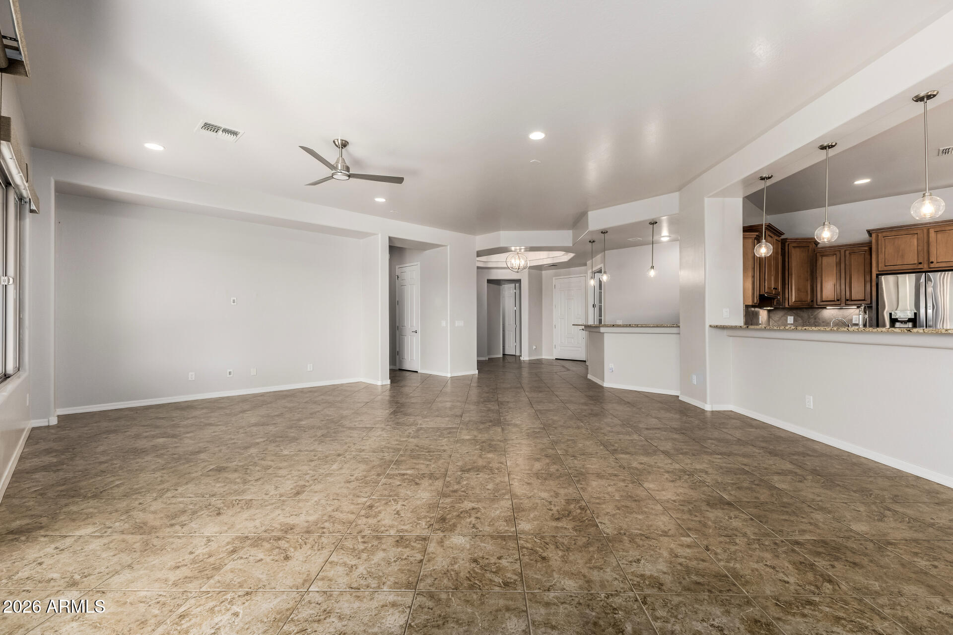 27119 West Burnett Road Buckeye, AZ 85396 - Photo 12 of 56 a view of a kitchen with a sink and a refrigerator