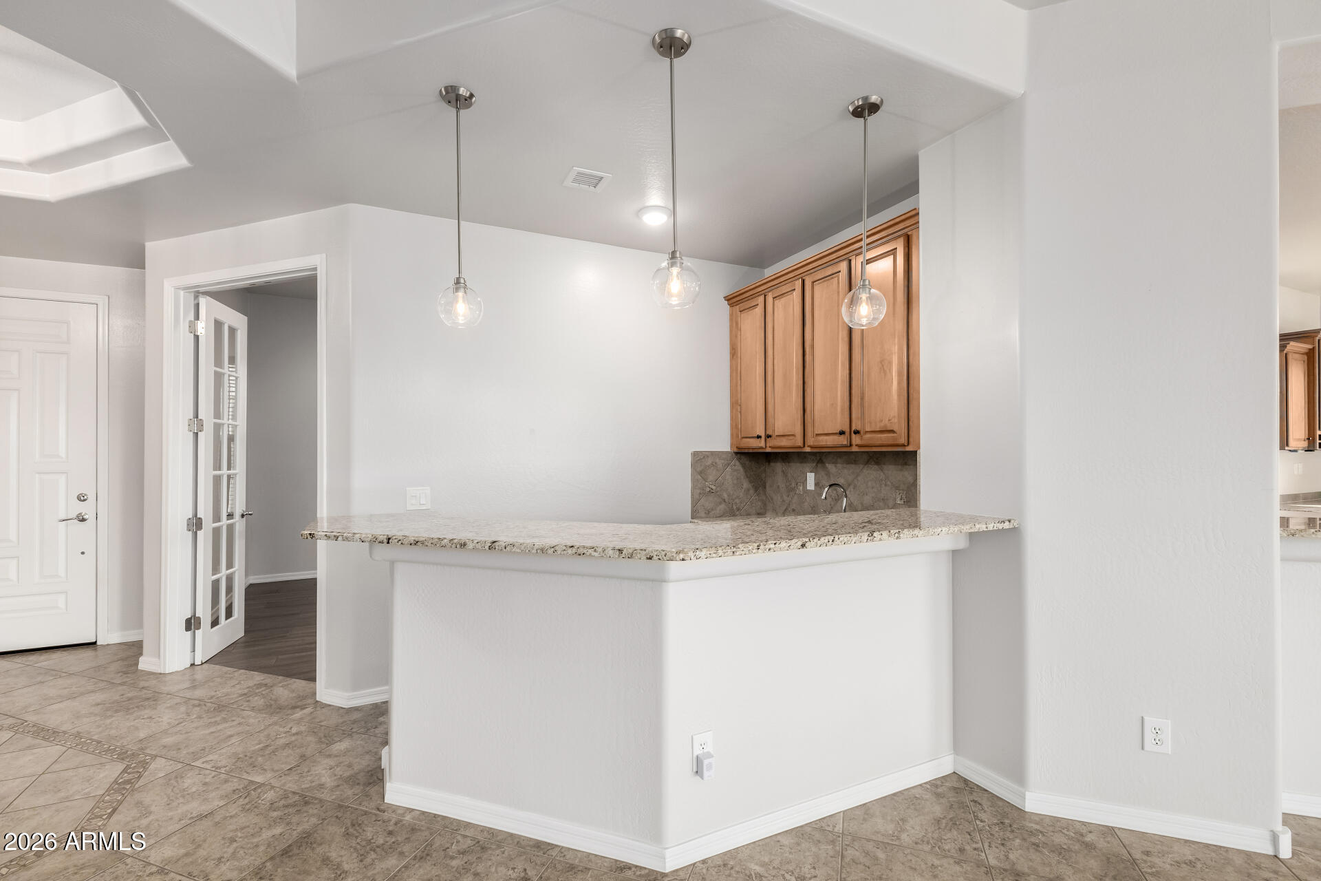 27119 West Burnett Road Buckeye, AZ 85396 - Photo 15 of 56 a view of a kitchen with a sink and dishwasher a refrigerator with wooden floor